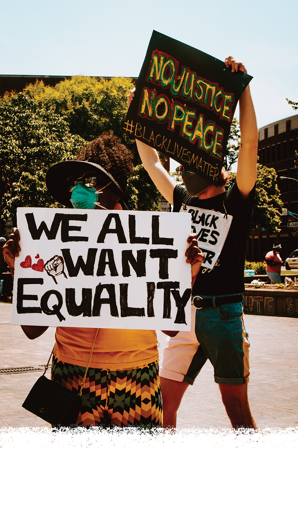 Signs reading "No Justice No Peace" and "We all want equality."